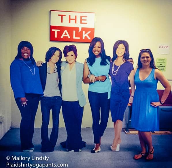 Mallory standing with cardboard cut outs of The Talk