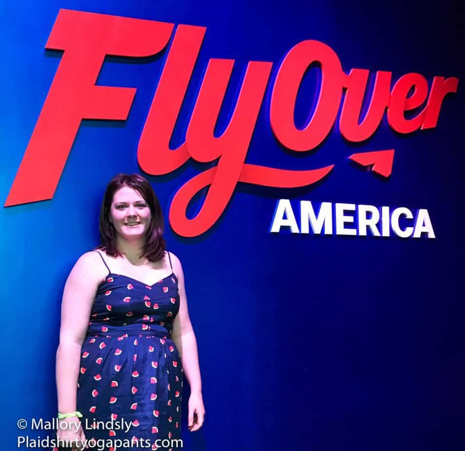 Mallory in front of the Fly Over America sign