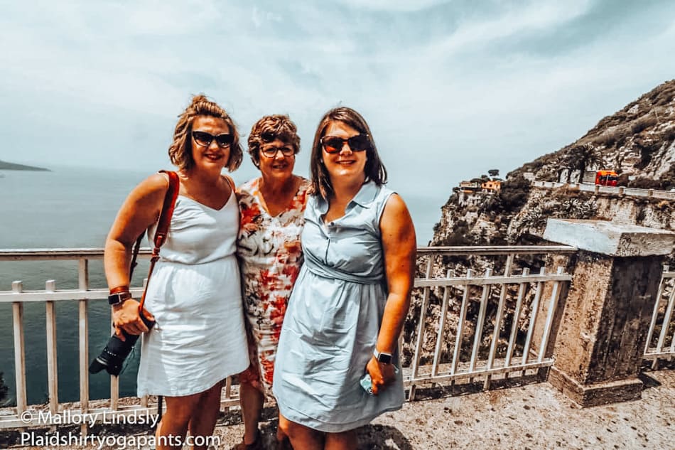 Three ladies standing on the italian coast. flying with a rollator