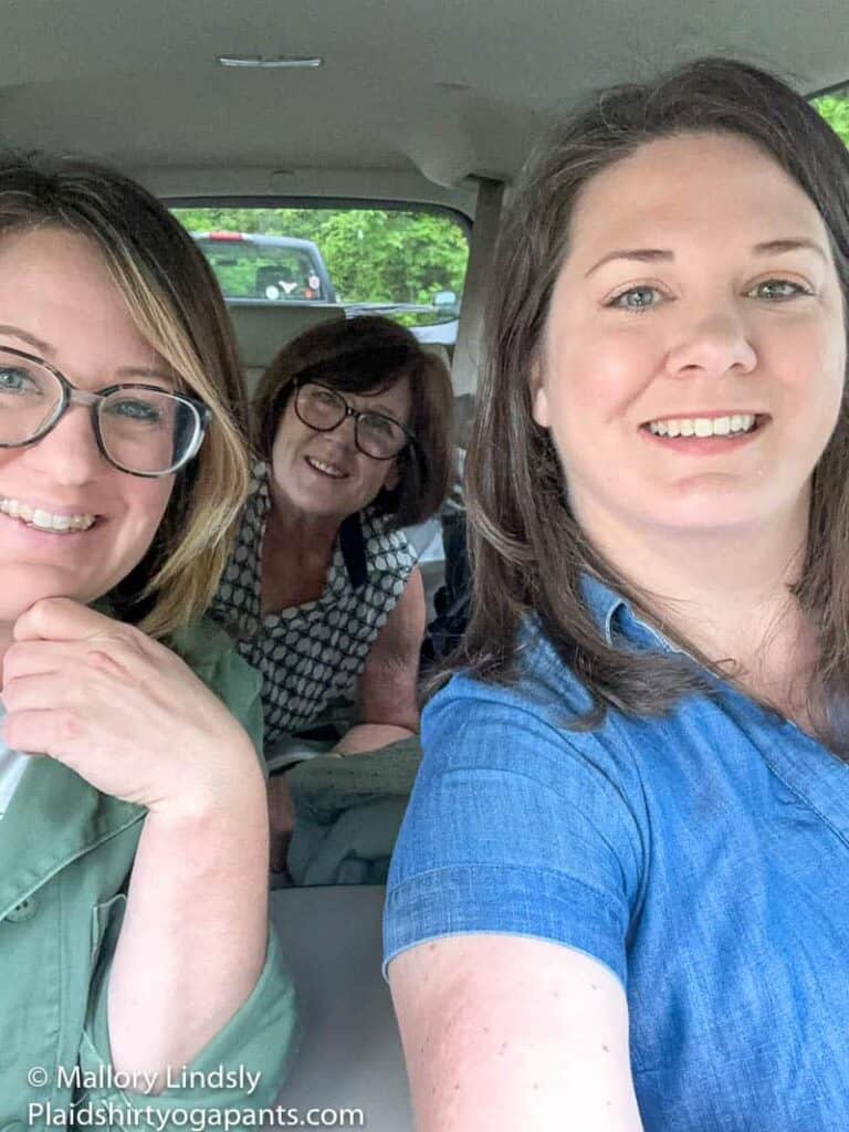 Three ladies driving in a car for a road trip