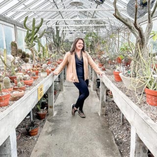 A lady standing in a indoor garden